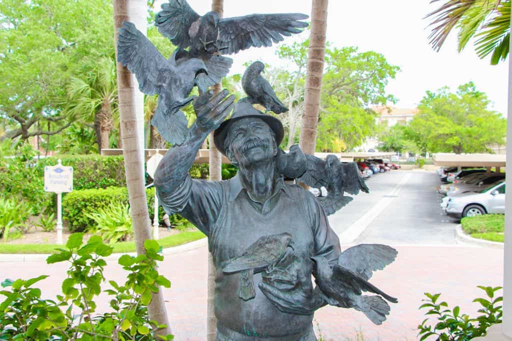 Sarasota Bay Club Condos - Man with Birds Statue