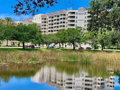 Woodmere at Jacaranda Condos in Venice, FL. - Building and Pond