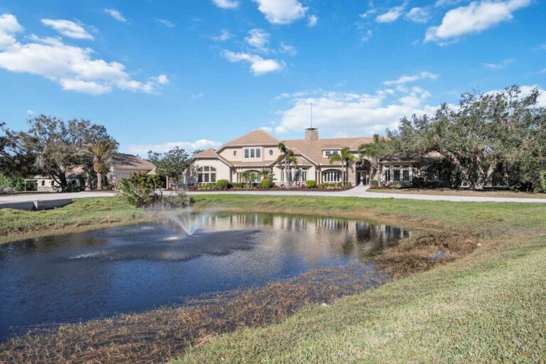 6200 Saddle Oak Trail in Sarasota FL - Aerial view across from a small lake with water fountain feature.