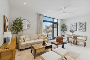 A welcoming view of stepping into the foyer and living room of 1558 4th Street Unit 402, which includes a stunning cityscape view from the outdoor balcony