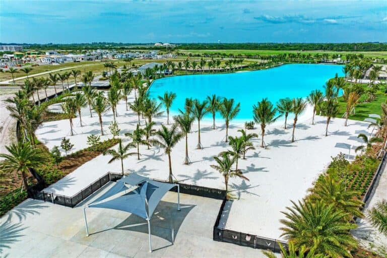 Swimming lagoon with palm trees at Aqua Lagoon Townhomes in Bradenton, Florida