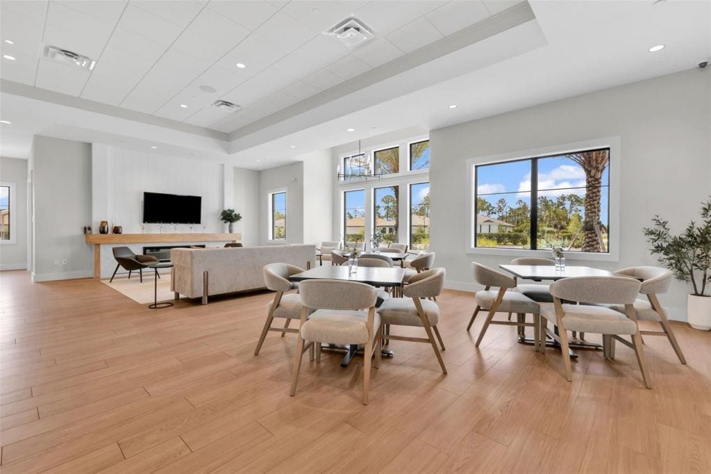 Common area with seating and large windows at Arbor Oaks in North Port, Florida
