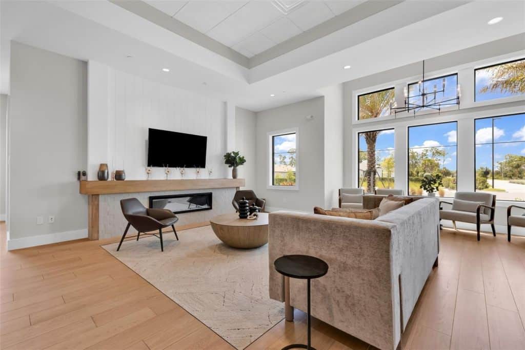 Living room with a TV and large windows at Arbor Oaks in North Port, Florida