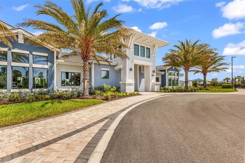 Clubhouse entrance with palm trees at Arbor Oaks in North Port, Florida